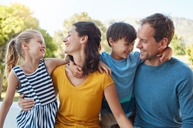 Parents showing compassion in parenting as they laugh and connect with their children, illustrating compassionate parenting and understanding children’s development.