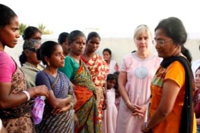 Becky Douglas speaking with women in India during service work with Rising Star Outreach and leprosy colonies