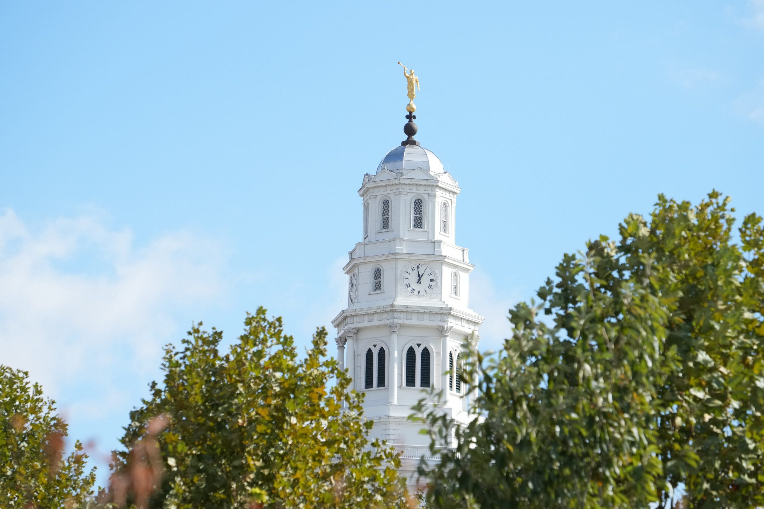 The Nauvoo Temple rising above trees in Nauvoo Illinois, rebuilt on the historic site of the temple completed under Brigham Young before the Saints’ exodus.