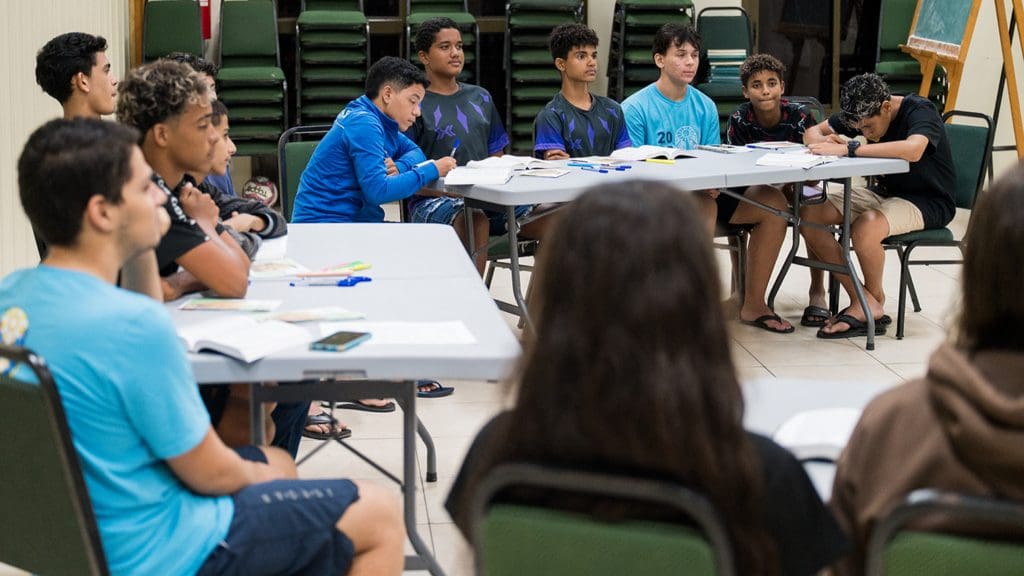Young men participate in a Seminary class discussion, reflecting the growth of the Seminary and Institute program and increasing worldwide enrollment.