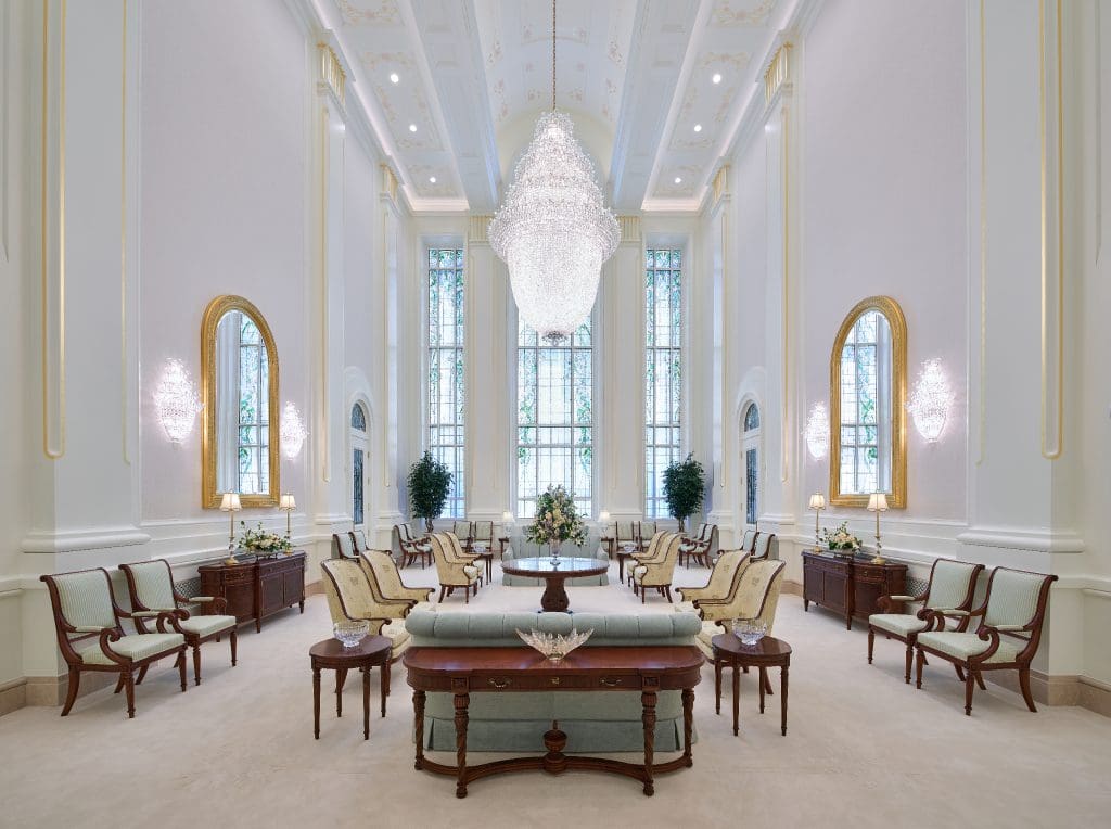 The celestial room inside the Lindon Utah Temple features elegant chandeliers, tall windows, and seating where worshippers reflect on the blessings of temple worship in The Church of Jesus Christ of Latter-day Saints.