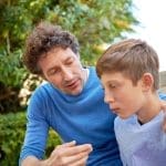 father guiding son outdoors showing effective parenting principles and compassionate parenting