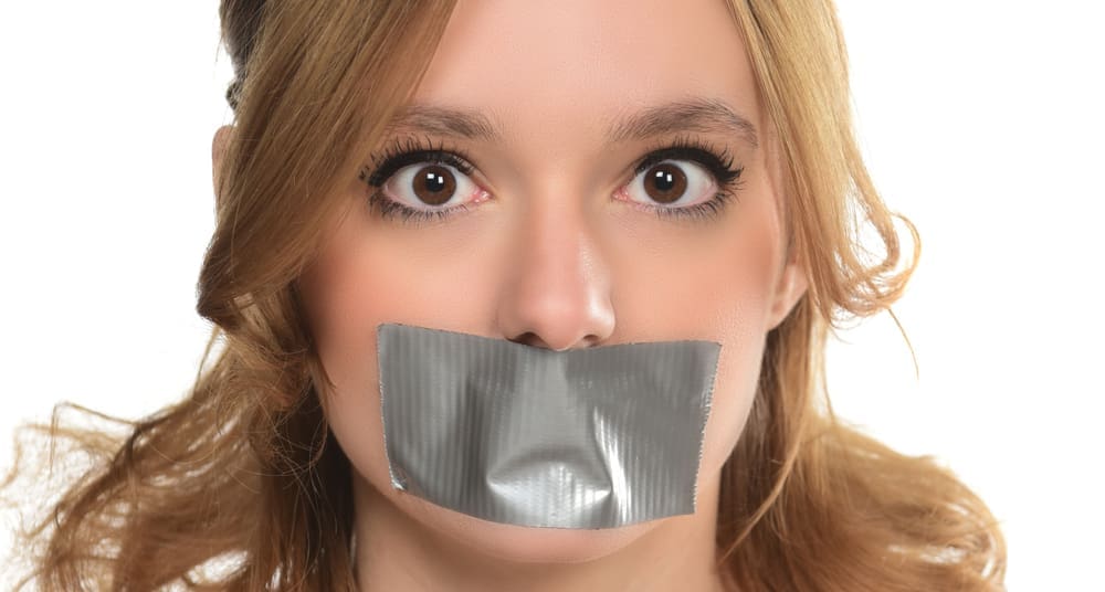 woman with mouth taped shut symbolizing therapy free speech restrictions Chiles v. Salazar Supreme Court counseling speech rights