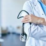 Doctor holding stethoscope representing near death experiences and life after death in Appointments with Heaven