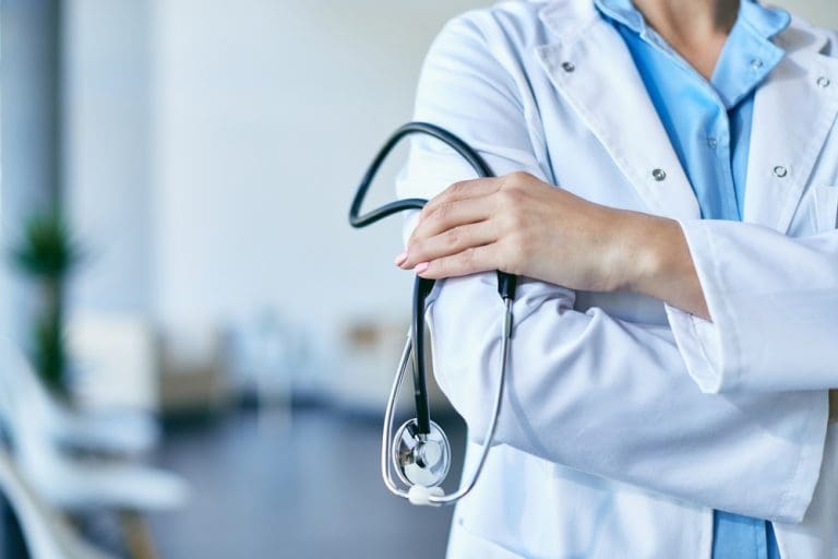 Doctor holding stethoscope representing near death experiences and life after death in Appointments with Heaven