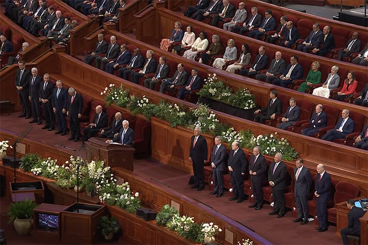 Church leaders standing during a solemn assembly at General Conference 2026, a key moment in this Church Report.