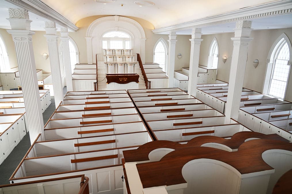 Interior of the Kirtland Temple with historic pews and pulpits, a sacred highlight of the Church History Tour where key Restoration events occurred.