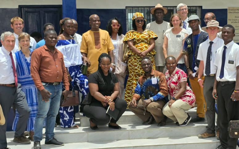Missionaries and local leaders gather after a Church humanitarian project in Africa, reflecting global service efforts.