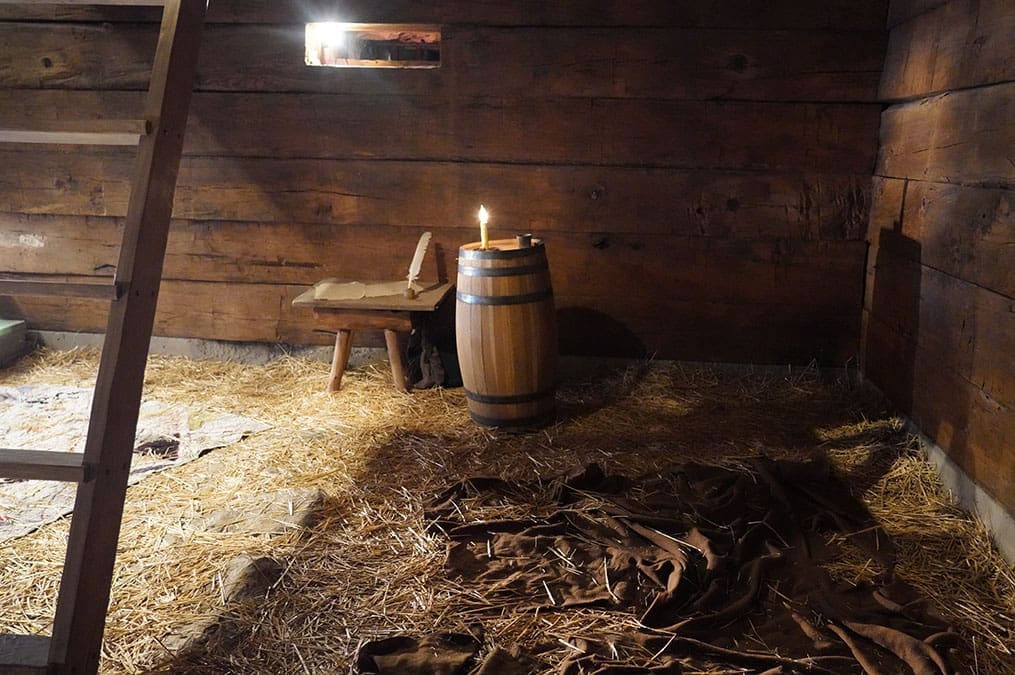 Reconstructed Liberty Jail interior where Joseph Smith was imprisoned, a powerful and sacred stop on the Church History Tour.