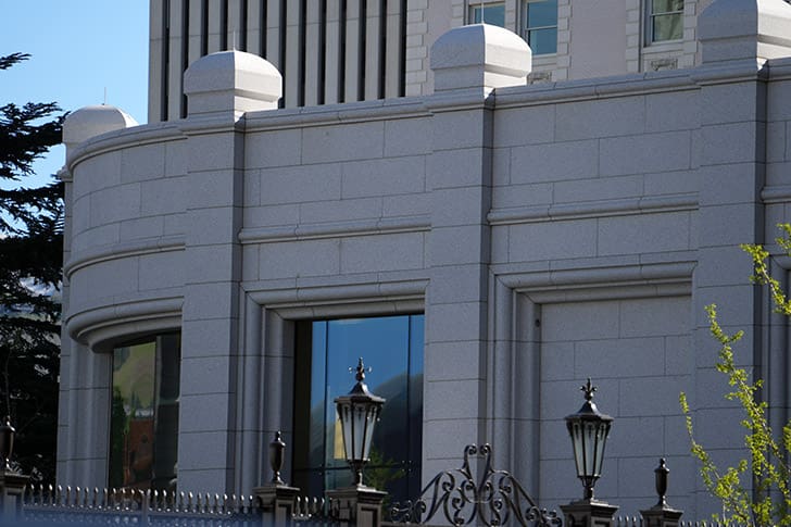 Exterior architectural detail of the Salt Lake Temple at Temple Square, showcasing the historic craftsmanship and ongoing renovation connected to the new Visitors’ Center experience.