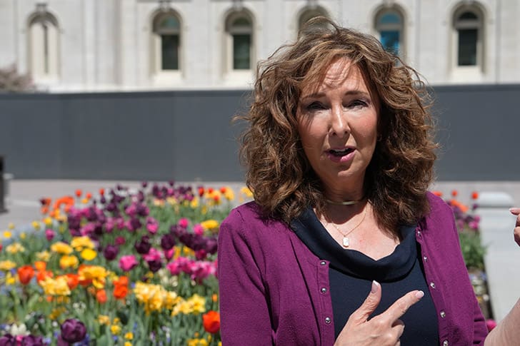 Amy Christensen, of Jacobsen Construction, standing in the gardens of Temple Square near the Salt Lake Temple, explaining the new Visitors’ Center experience.