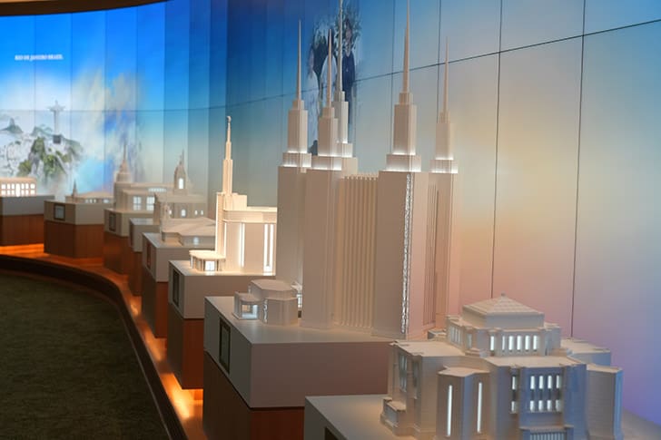 Display of detailed temple models from around the world inside the Temple Square Visitors’ Center, highlighting global Latter-day Saint temple architecture.