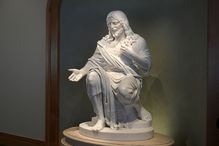 Marble statue of Jesus Christ inside the Temple Square Visitors’ Center, emphasizing His central role in Latter-day Saint beliefs and temple worship.