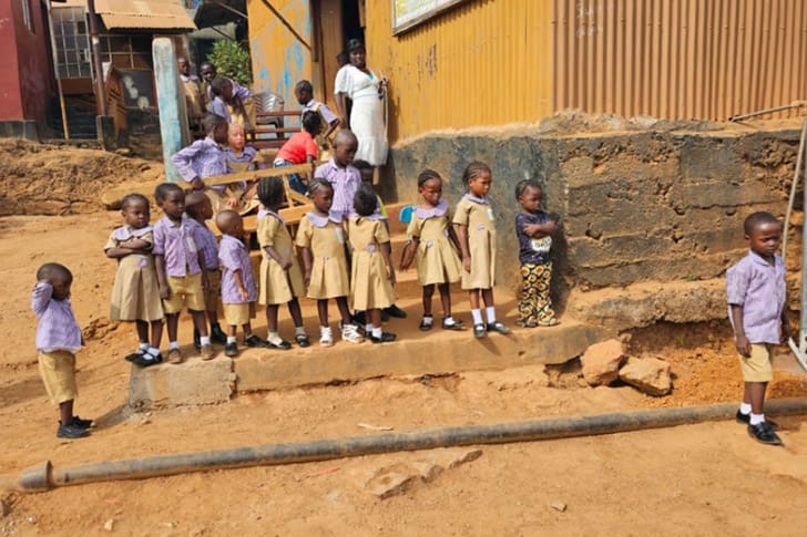 Young children gathered near a newly supported education and sanitation site in Africa, part of Church humanitarian aid efforts.