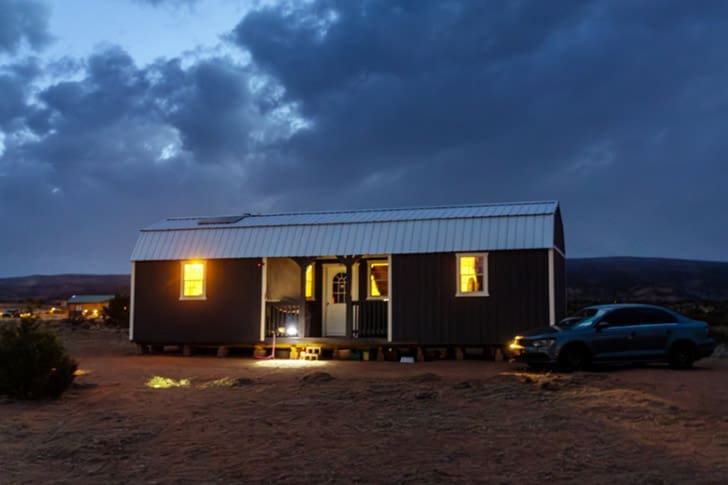 A home in the Navajo Nation illuminated at night, representing humanitarian outreach and solar power initiatives.