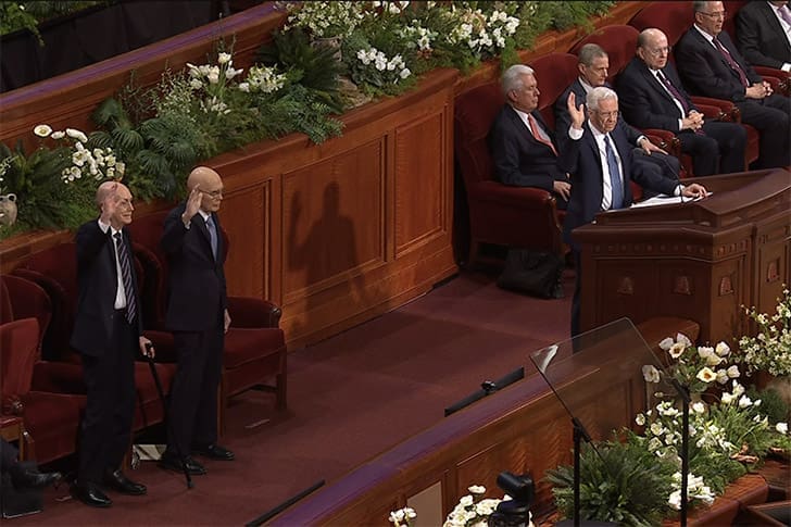 Church leaders standing during a solemn assembly at General Conference 2026, a key moment in this Church Report.