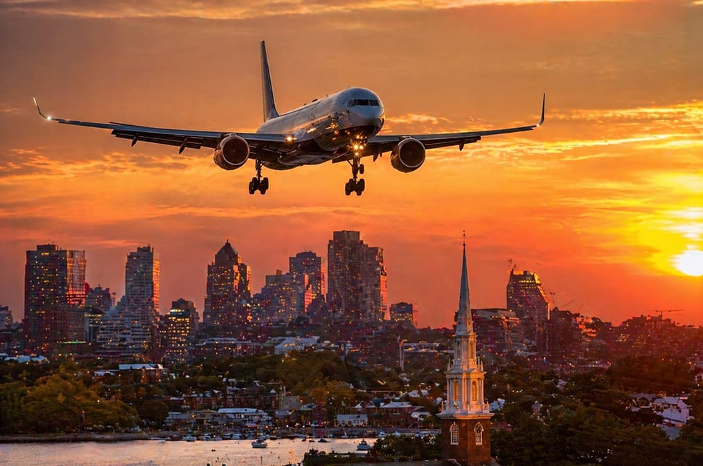 An airplane descends over Boston at sunset, marking the beginning of this Church History tour as participants gather to explore early Church history and Joseph Smith sites.