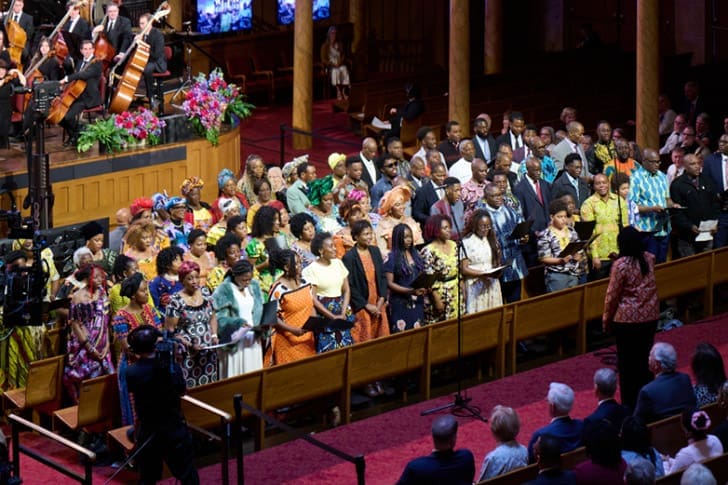 Large choir and congregation gathered for a Tabernacle Choir broadcast event expanding into African nations.