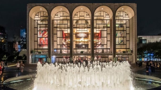 Metropolitan Opera House at Lincoln Center illuminated at night during the debut of Rob Gardner’s Lamb of God oratorio highlighting the Easter season and Jesus Christ.