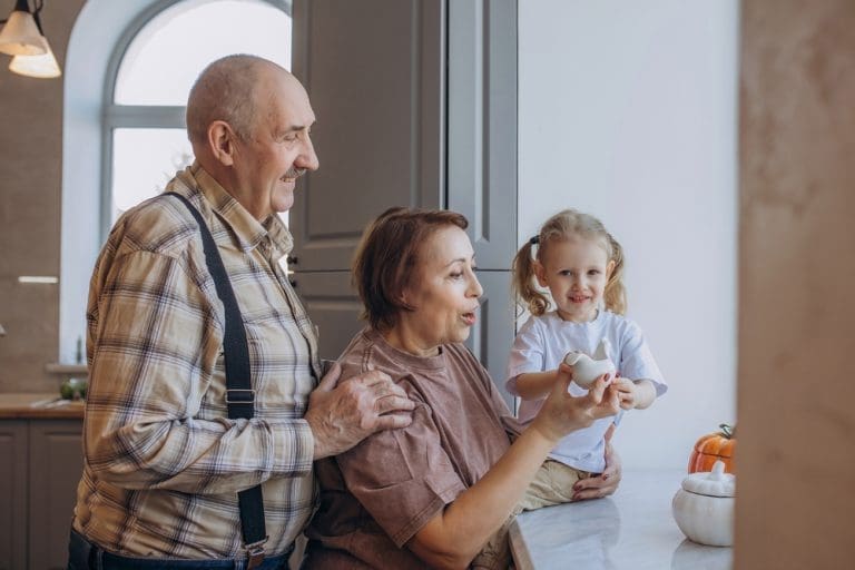 Grandparents and granddaughter sharing a joyful family moment that reflects bonding, emotional empathy, and loving grandparent relationships.