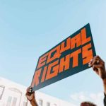 Person holding an Equal Rights sign representing fairness for men and women, men’s rights, women’s rights, parental rights, and mental health awareness