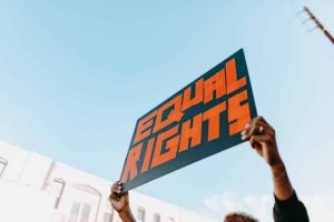 Person holding an Equal Rights sign representing fairness for men and women, men’s rights, women’s rights, parental rights, and mental health awareness