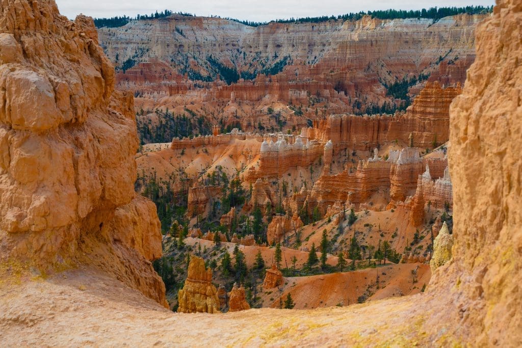 A canyon opening reveals sweeping Bryce Canyon cliffs and hoodoos, reflecting the article’s theme that answers from God often come as a limited window instead of a full map during the Ocean to Ice expedition.