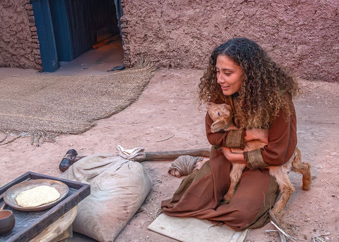 Talia tenderly holds her baby goat, Chad Gaya, during filming for the Parables Project, highlighting the compassion, devotion, and emotional depth woven into this cinematic adaptation of Matthew 25.
