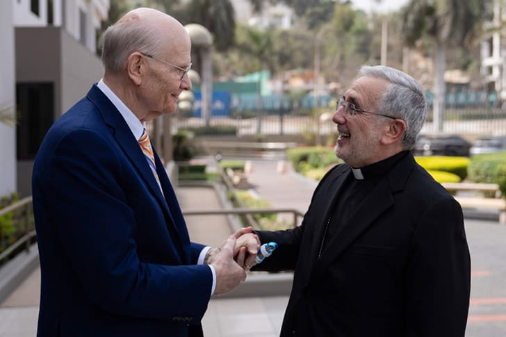 Elder Dale G. Renlund greets Archbishop Javier Del Río Alba during a ministry visit to Peru, highlighting friendship, interfaith respect, and humanitarian cooperation.