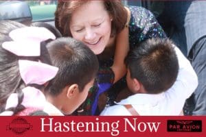Camille N. Johnson greets children during a humanitarian outreach visit featured in Hastening Now Church of Jesus Christ of Latter-day Saints news update