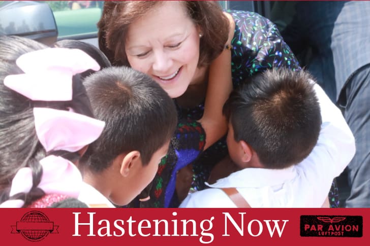 Camille N. Johnson greets children during a humanitarian outreach visit featured in Hastening Now Church of Jesus Christ of Latter-day Saints news update