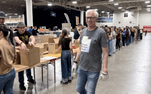 Volunteers packing food boxes at Silicon Slopes Serves Meals to support Utah families in need and fight food insecurity.