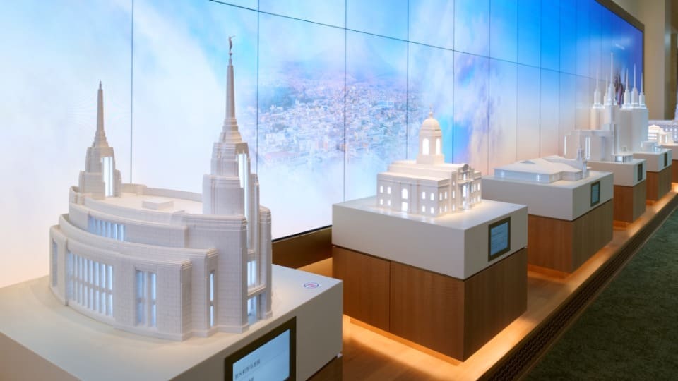 Temple models inside the new Temple Square Visitors’ Center in Salt Lake City featuring exhibits about Latter-day Saint temples and Jesus Christ.