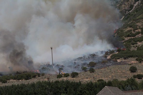 Alpinefire burningtreesandbackhoe